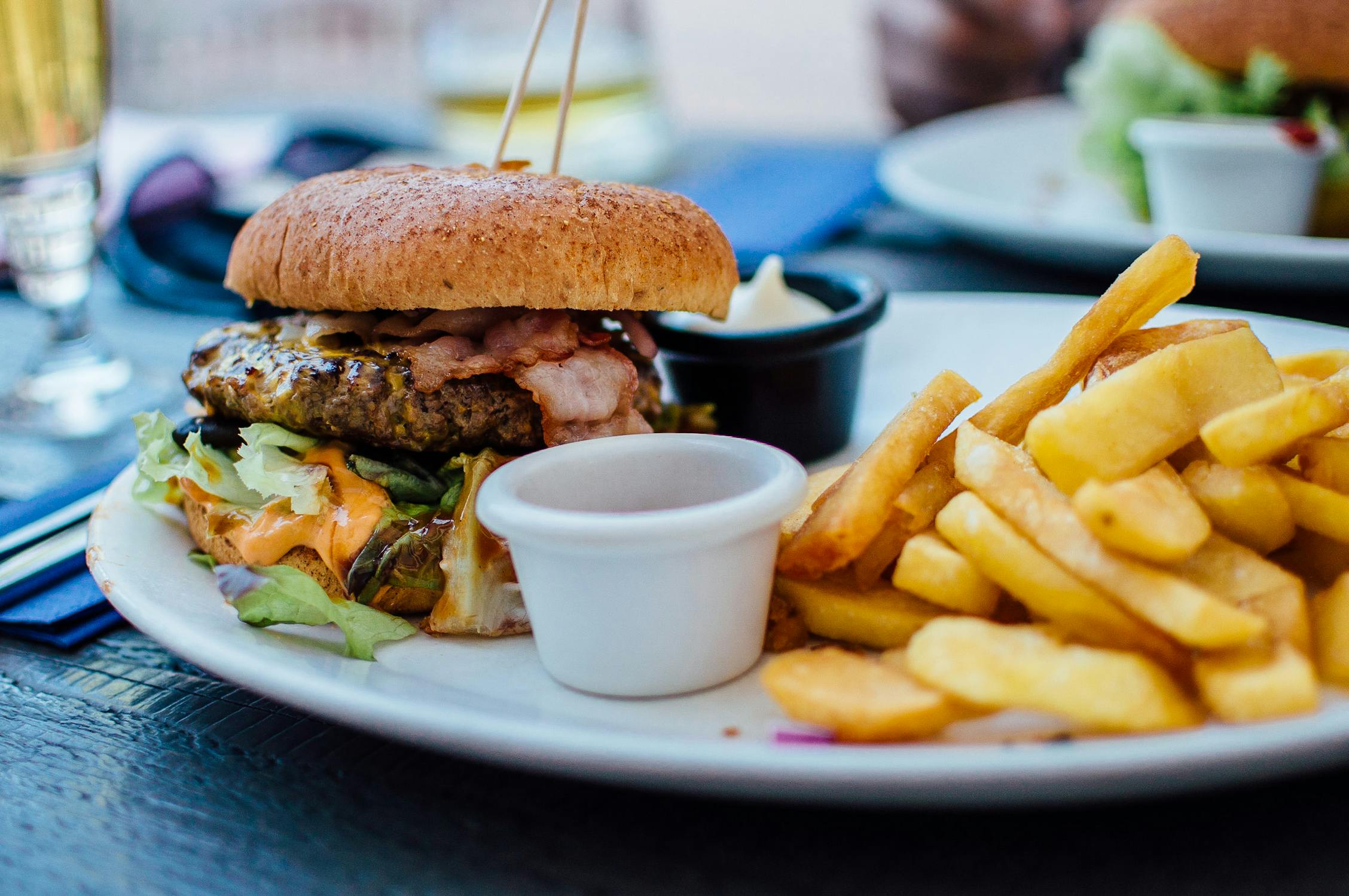 Burger and fries served on a plate.